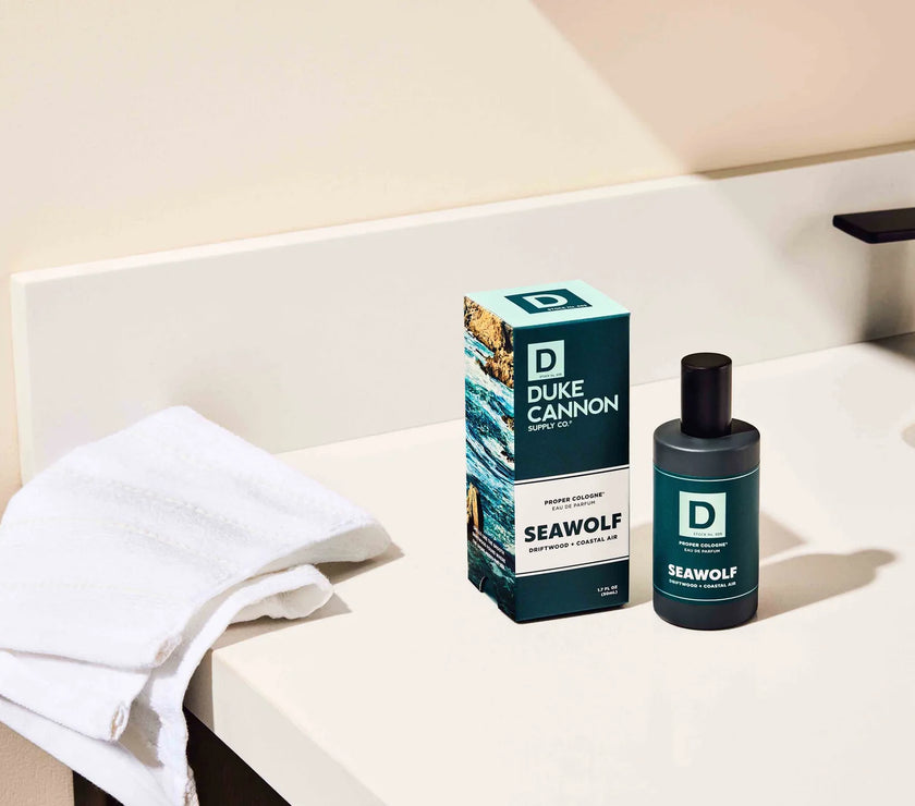 Duke Cannon Seawolf product on a bathroom counter with a towel and soap dispenser.