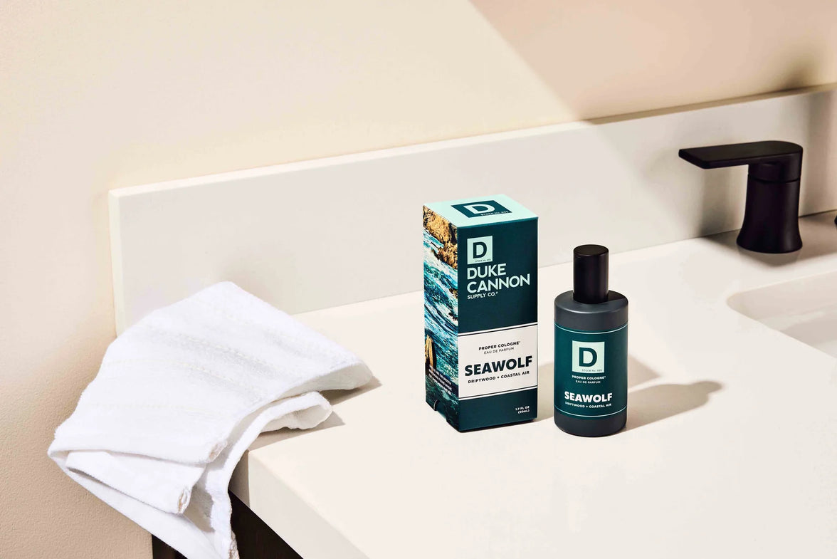 Duke Cannon Seawolf product on a bathroom counter with a towel and soap dispenser.