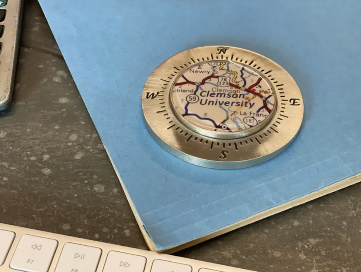 A pewter paperweight featuring a map inside