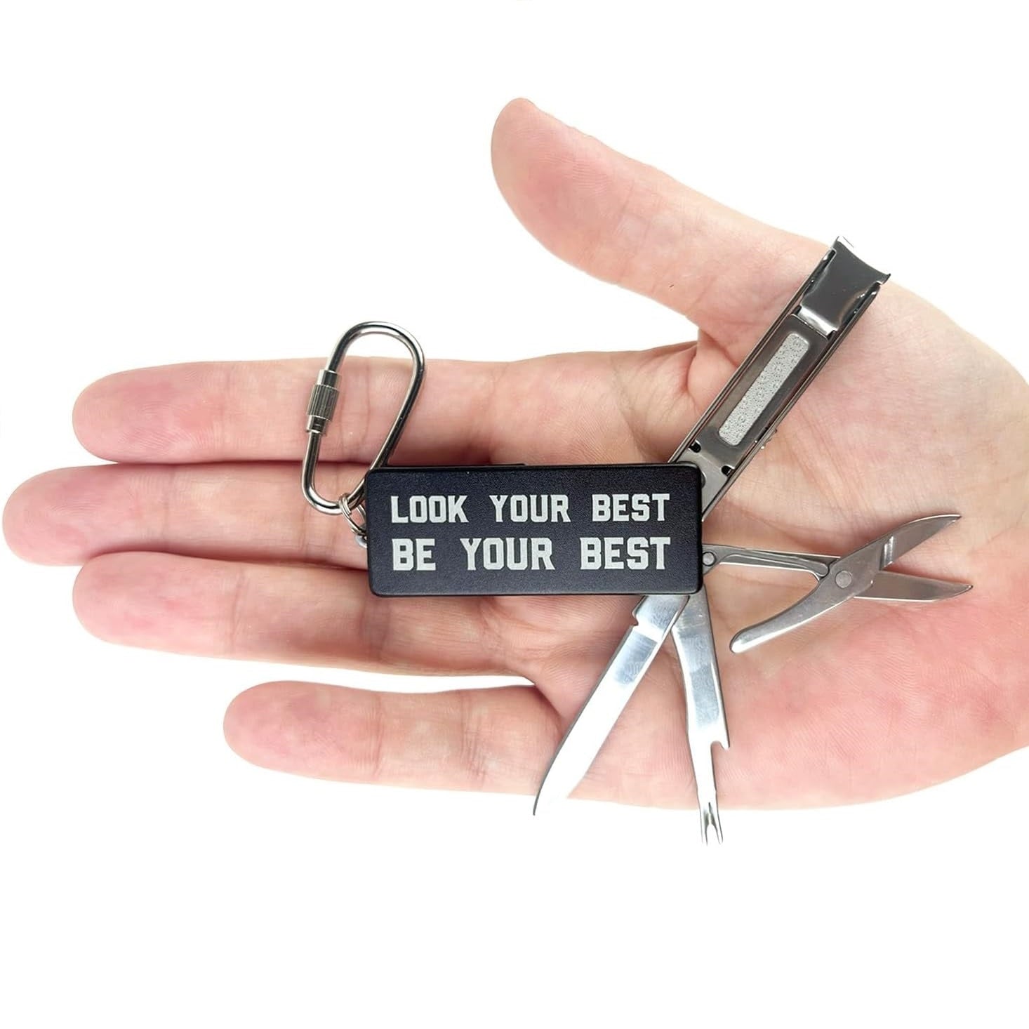 Multitool keychain with motivational tag held in a hand on a white background
