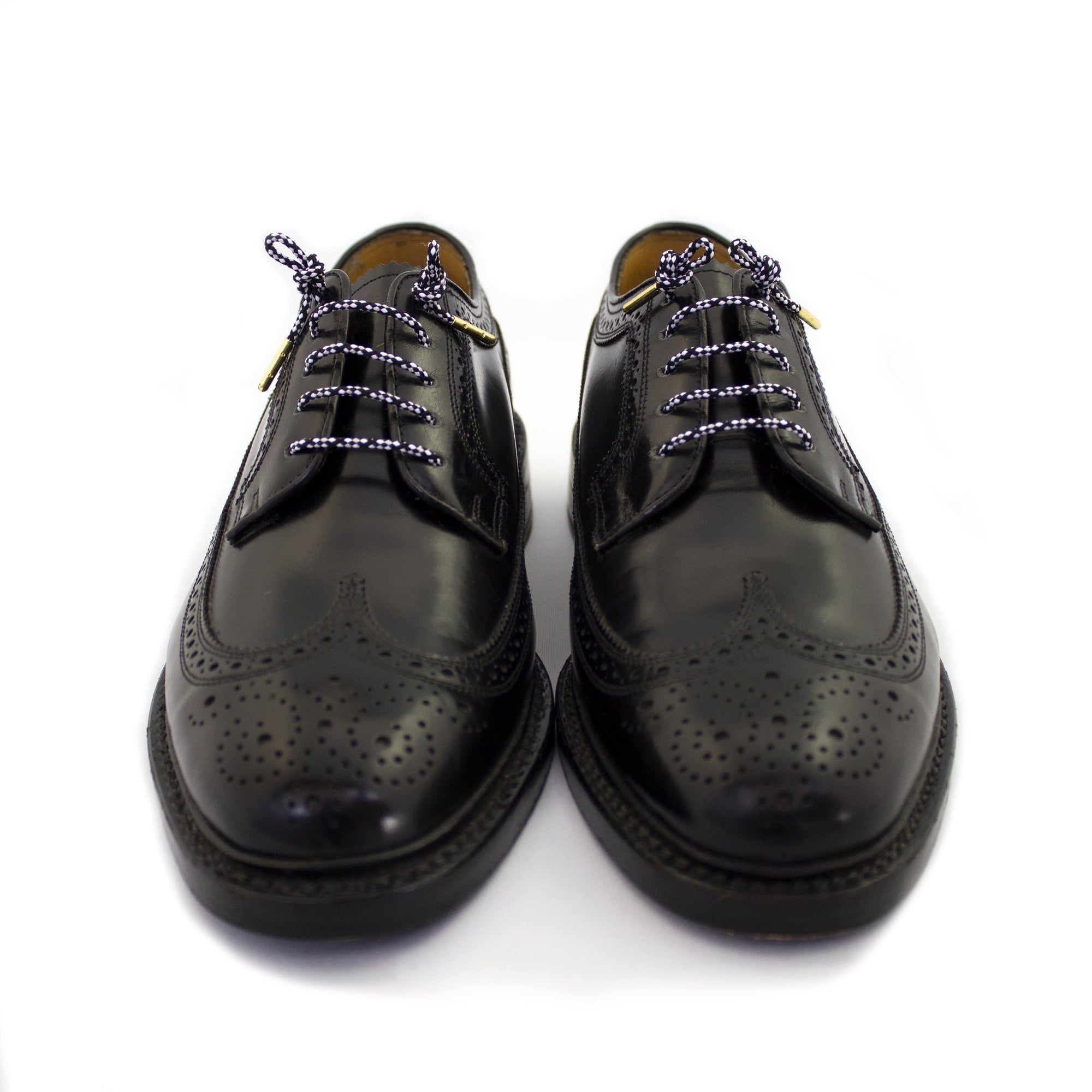 Black shoes with black and white shoe laces.