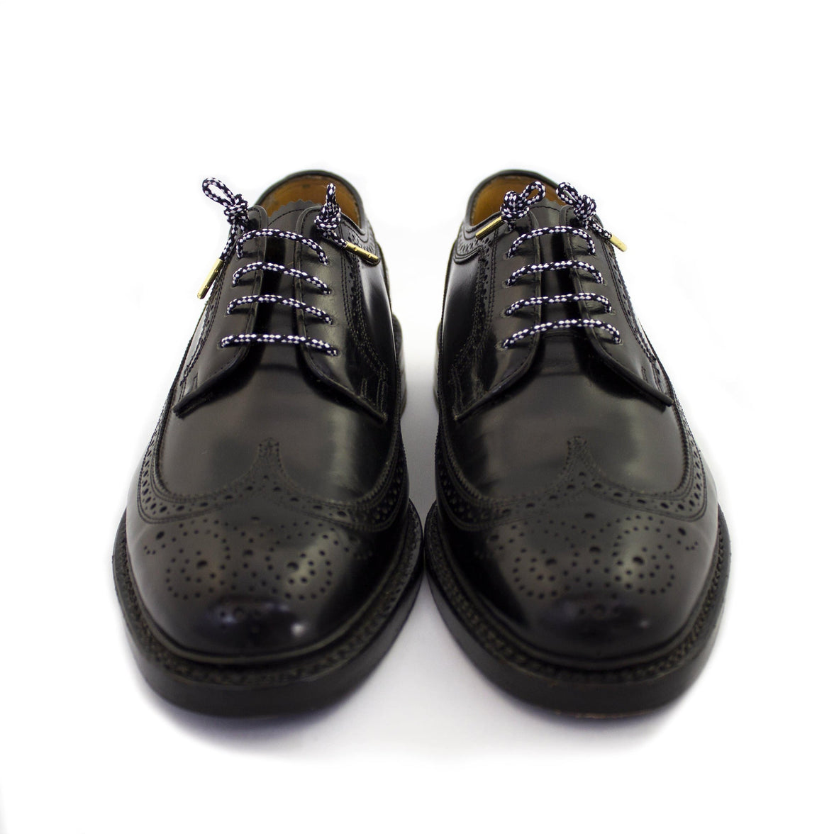 Black shoes with black and white shoe laces.