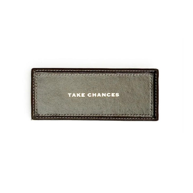 Black leather tray with 'TAKE CHANCES' text on a white background