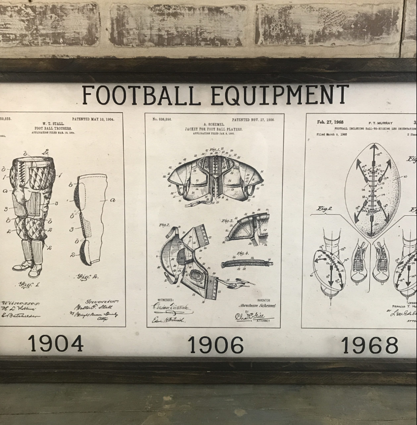 A close up look at a framed vintage football patent art piece with a wood frame, featuring text and illustrations related to football equipment.