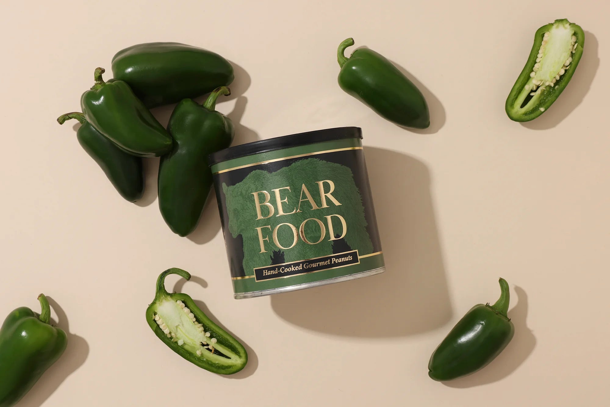 Can of 'Bear Food' surrounded by jalapeño peppers on a beige background