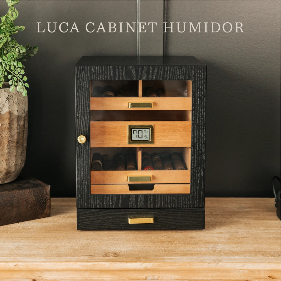 A black ash wood humidor cabinet with gold-plated hardware, featuring a digital display and multiple cigar drawers.
