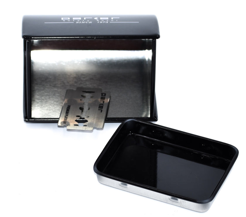 An open black metal Parker blade disposal bank showing a razor blade inside.