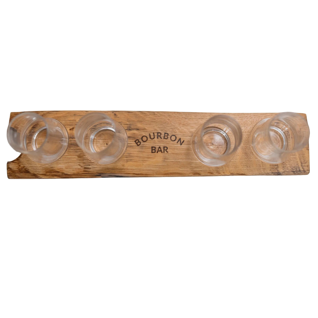Wooden bourbon bar with four glass holders on a white surface.