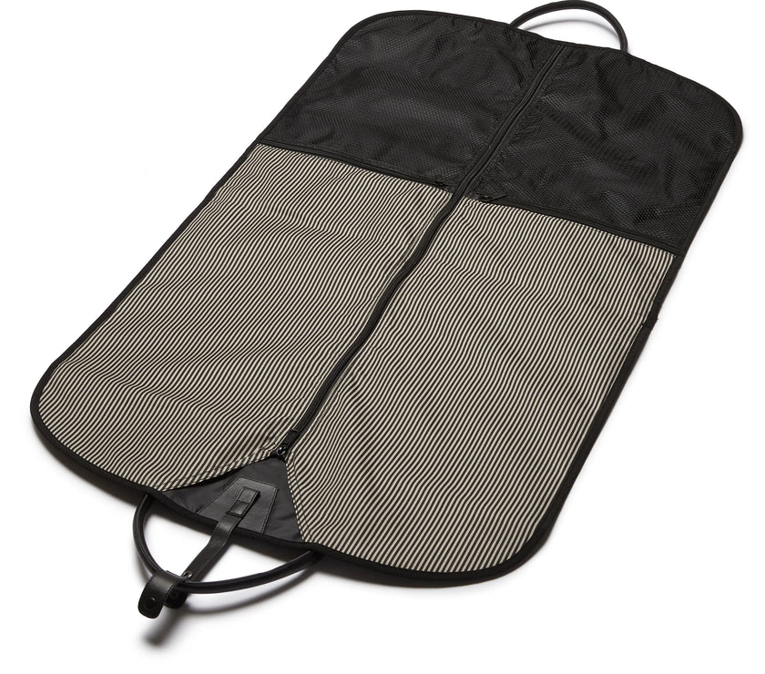 Black and gray garment bag open to show the interior with with a zipper on a white background