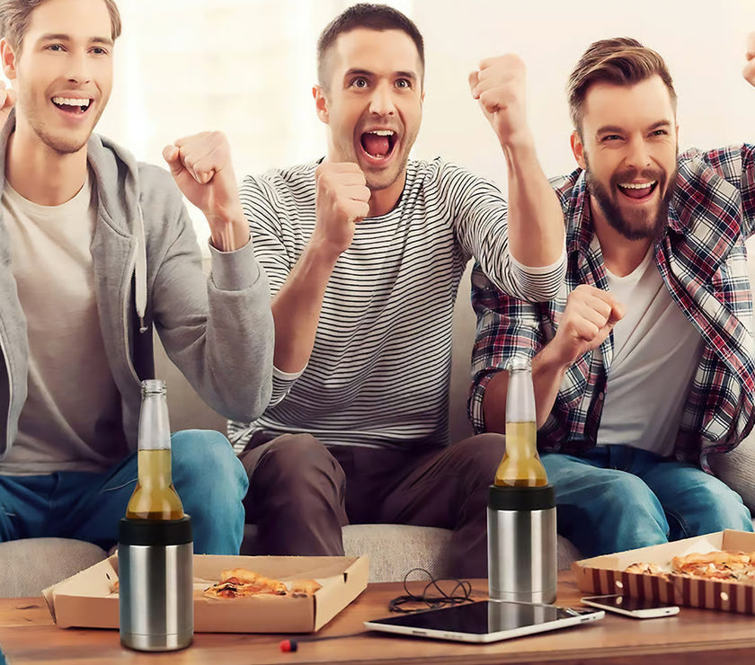 Three men celebrating with raised fists at a sports event, surrounded by snacks and bottles in stainless steel bottle holders.
