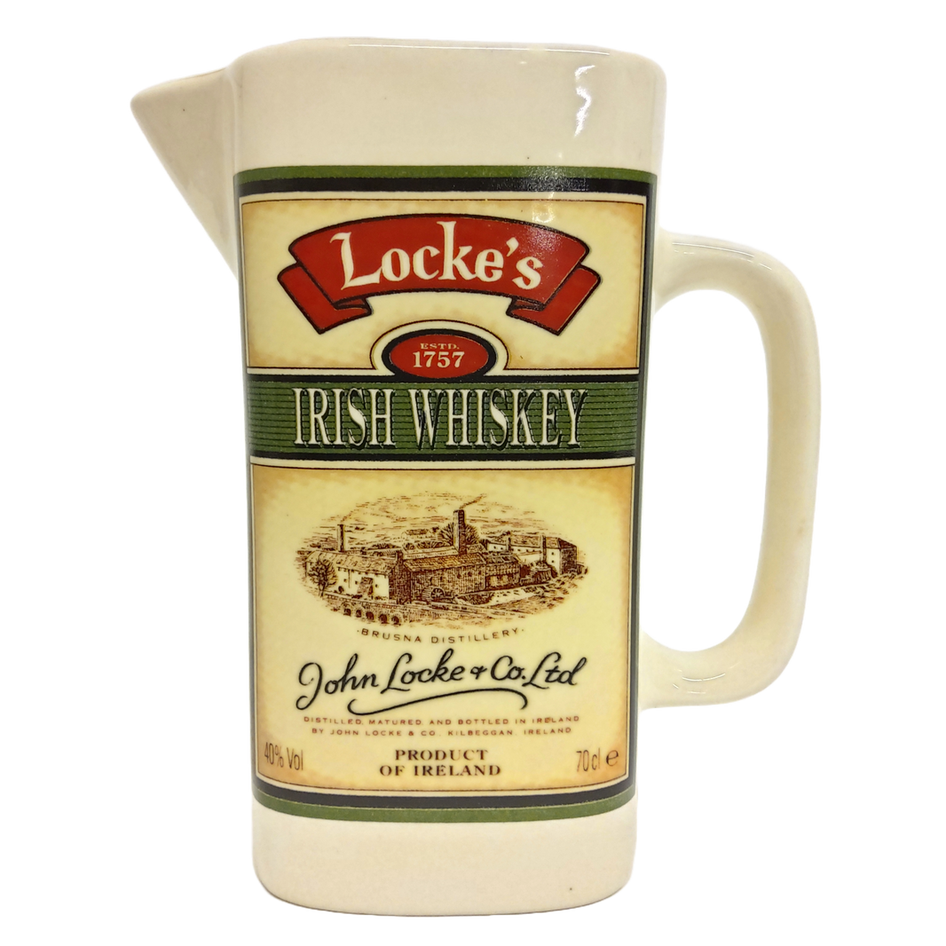 A cream-colored ceramic Locke's Irish Whiskey pitcher with a handle and spout, featuring vintage-style decals.