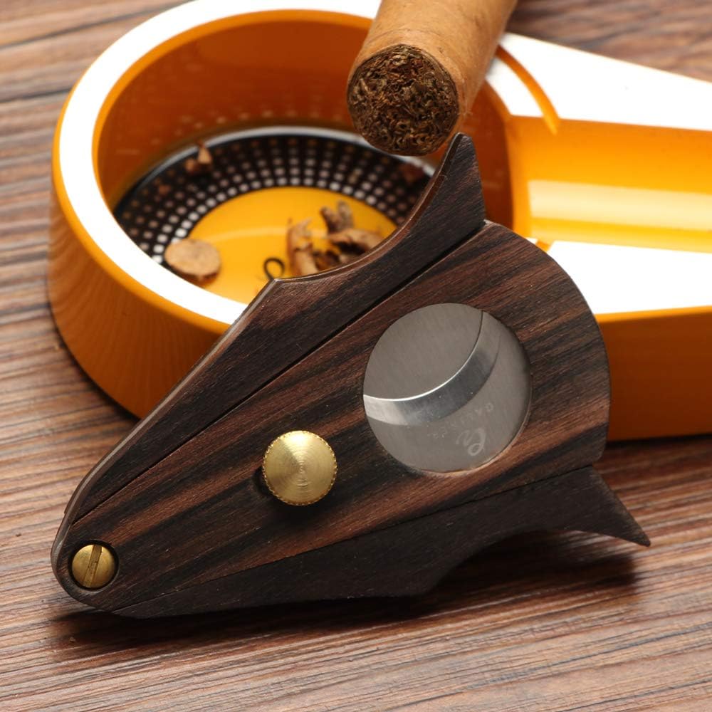 Cigar cutter with wooden handle and metal blade on a wooden surface