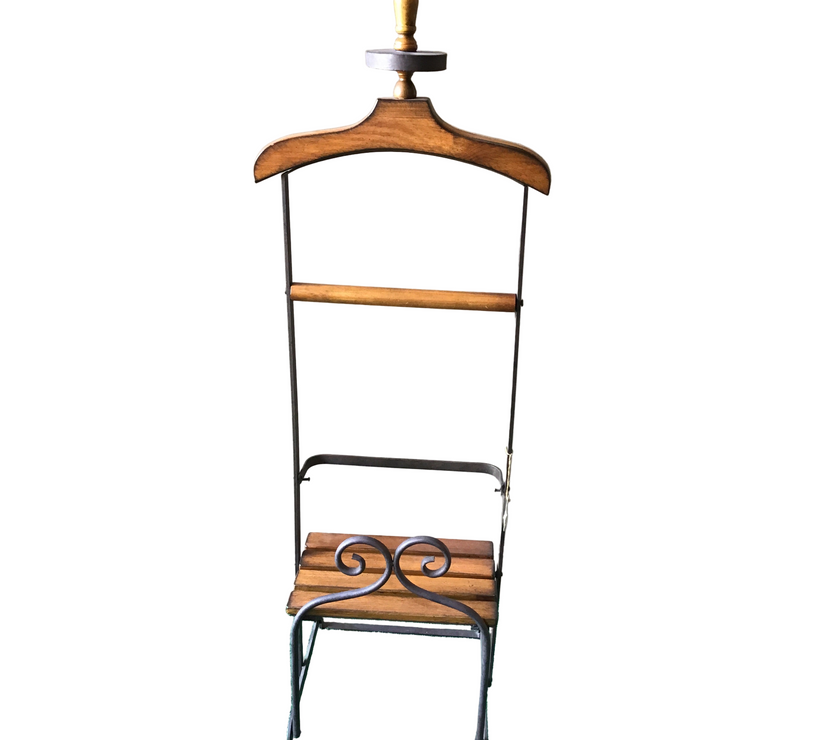 A clothing valet stand made of wood and metal.