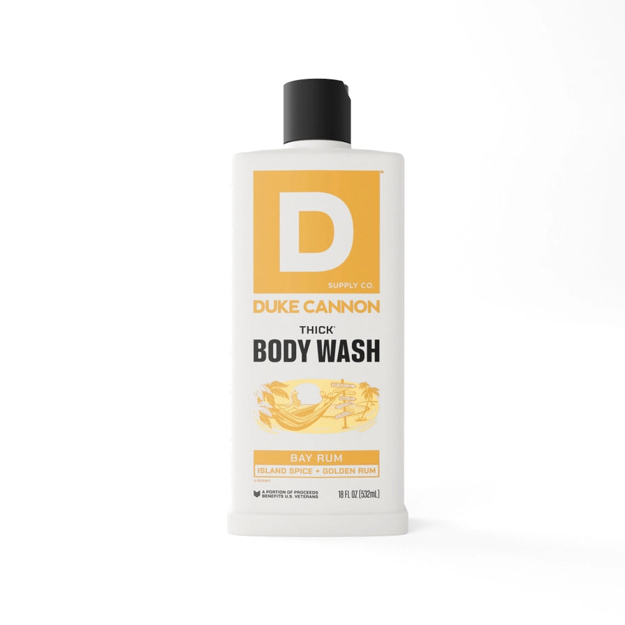 A white bottle of Duke Cannon thick body wash with a black cap and a prominent 'D' logo in orange. The label also indicates the scent as 'Bay Rum'.