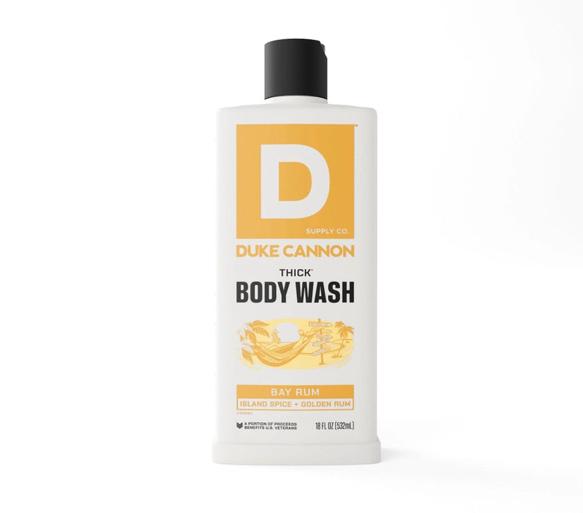 A white bottle of Duke Cannon thick body wash with a black cap and a prominent 'D' logo in orange. The label also indicates the scent as 'Bay Rum'.