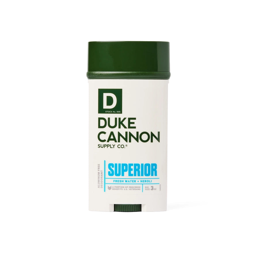 A white stick deodorant with a green cap labeled 'Duke Cannon Supply Co. SUPERIOR' with blue and green text on the label.