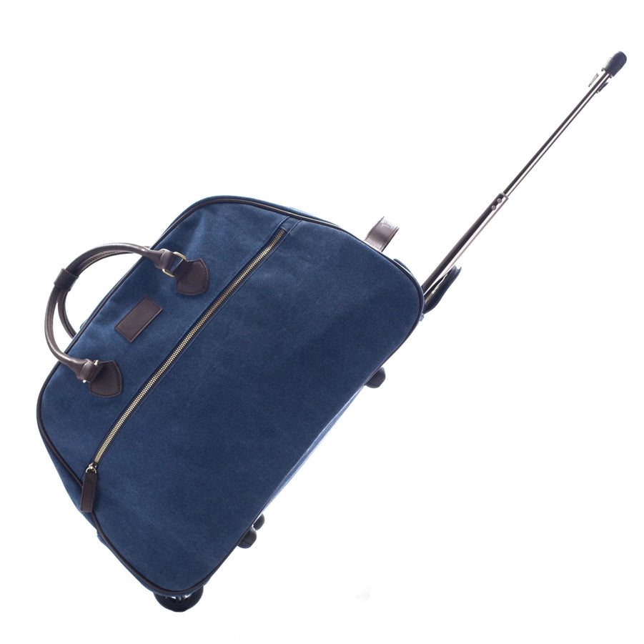 A blue Trolley Rolling Duffel with a zippered pocket on the exterior and the handle extended to show its rolling ability.