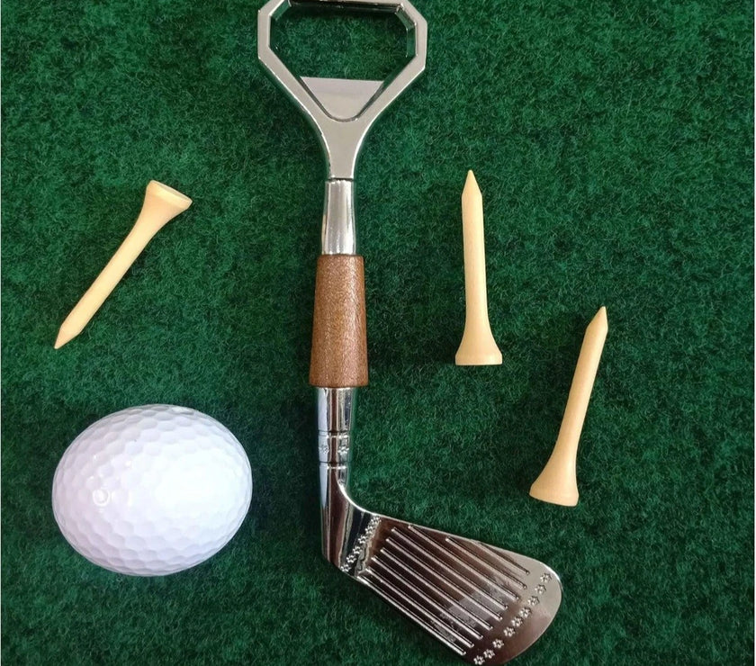 Golf club bottle opener with golf ball and tees on a green background