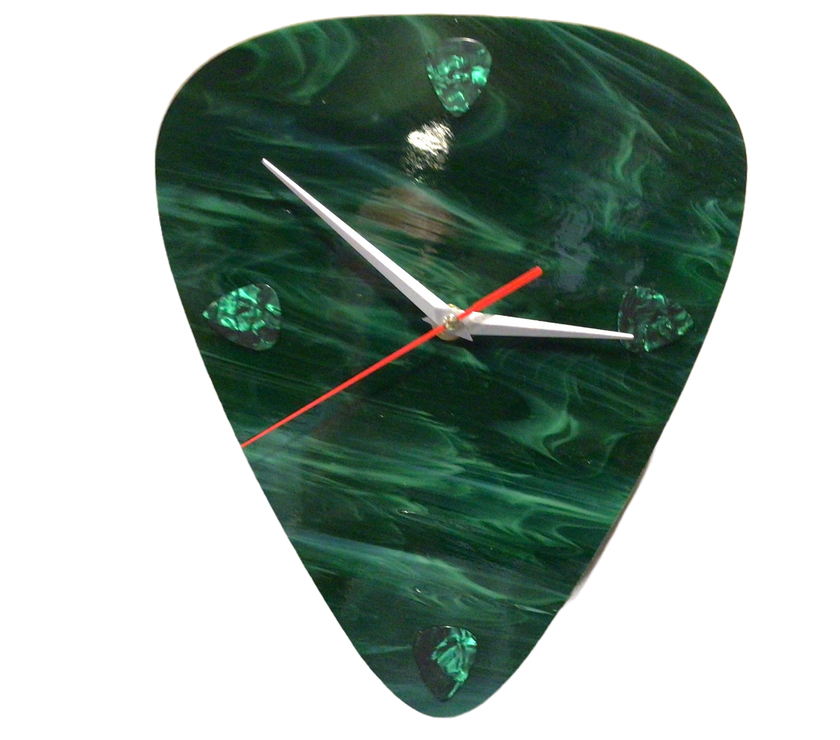 A jade-colored clock made of glass in the shape of a guitar pick