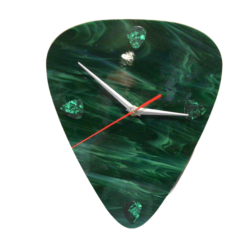 A jade-colored clock made of glass in the shape of a guitar pick