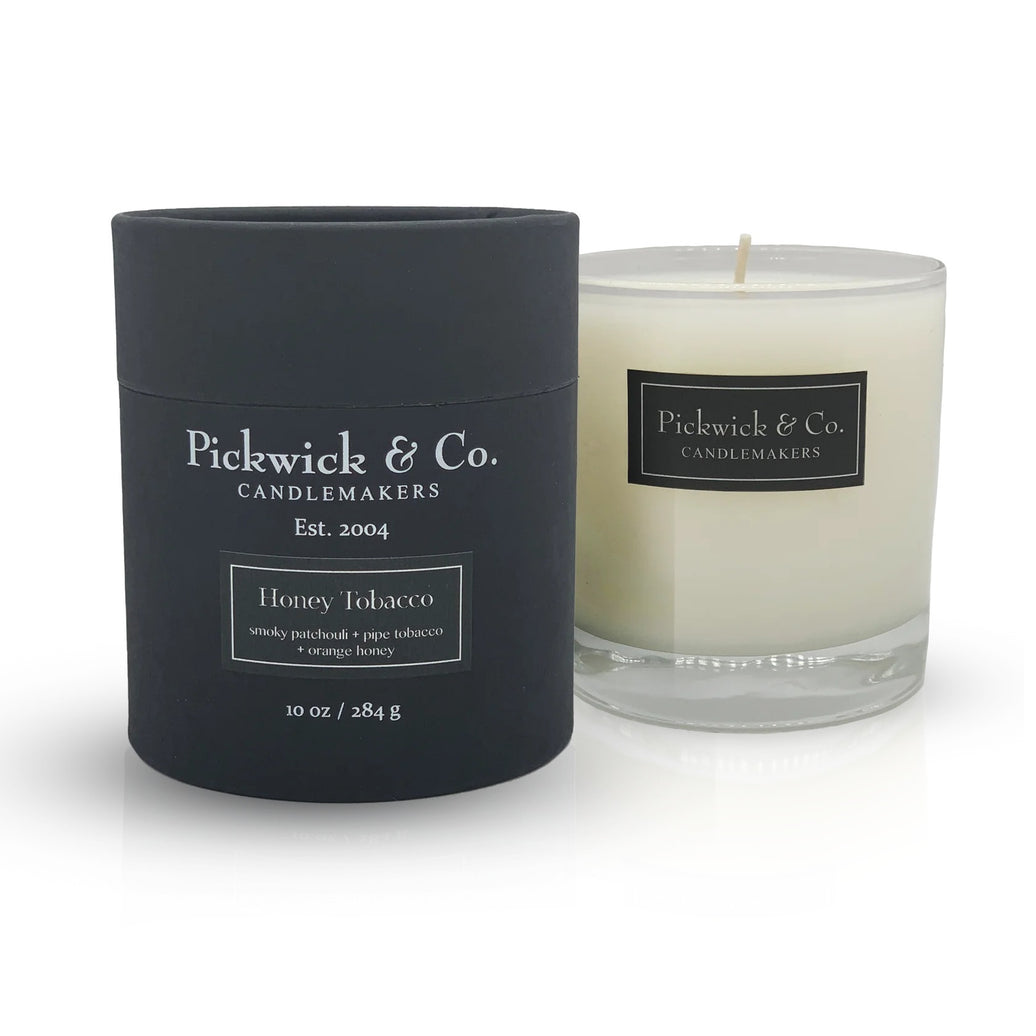 Honey Tobacco Pickwick & Co. candle beside it's black packaging on a white background.