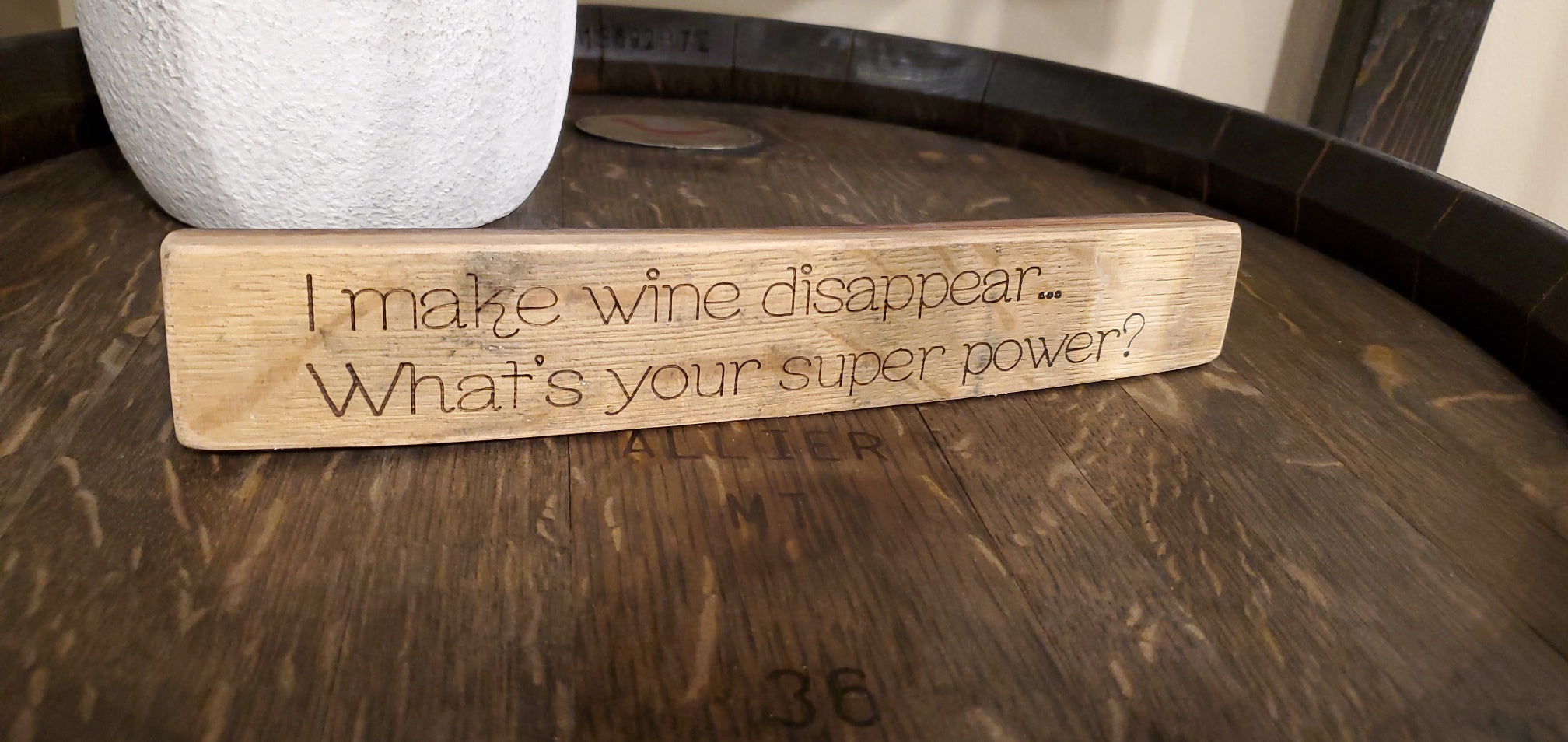 Wooden block with engraved text on a wooden surface