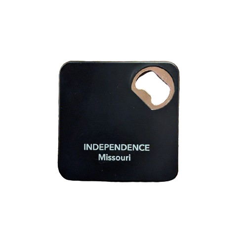 A square black metal bottle opener with coaster functionality, featuring the text 'INDEPENDENCE Missouri' on the top, with a metal opener inset.