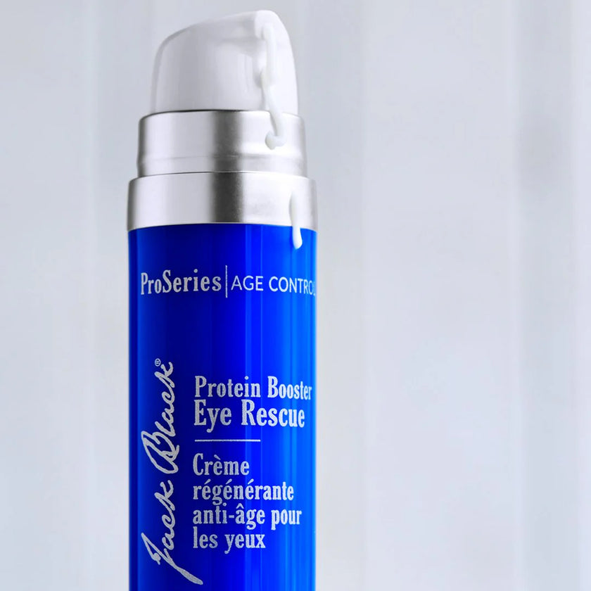Blue skincare bottle labeled 'Protein Booster Eye Rescue' on a light gray background