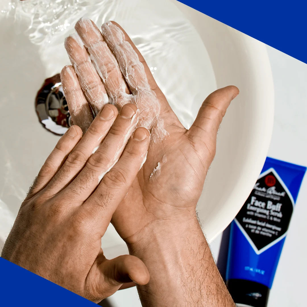 A person putting Jack Black Face Buff on their hands for use.