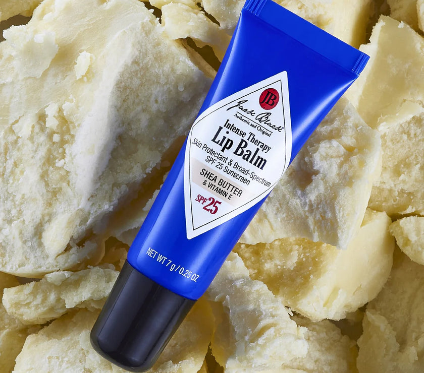 Blue lip balm tube on a textured beige background