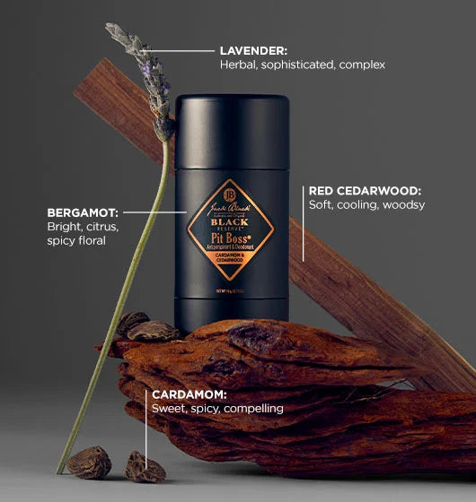 Jack Black Pit Boss Antiperspirant with items surrounding it, such as cardamom and red cedarwood to describe its scents.