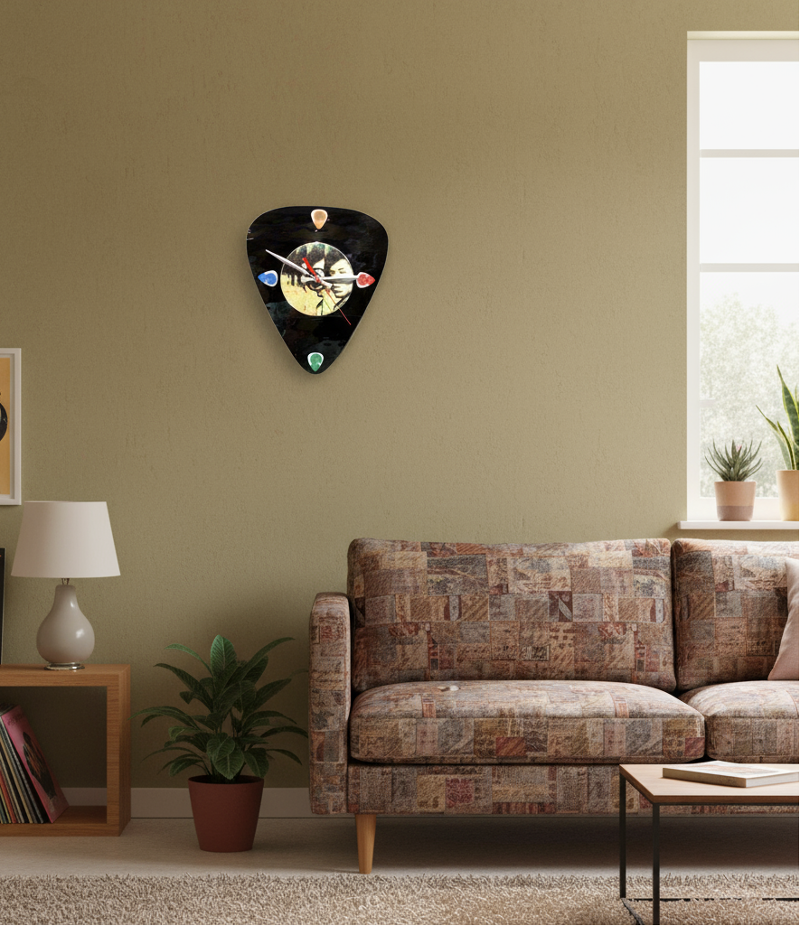 Living room with a guitar pick-shaped clock on the wall, a couch, and a shelf with books and a lamp.