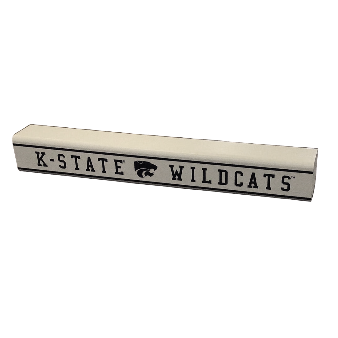 A small rectangular wooden sign with 'K-State Wildcats' printed on it in black with the school's logo in the middle.