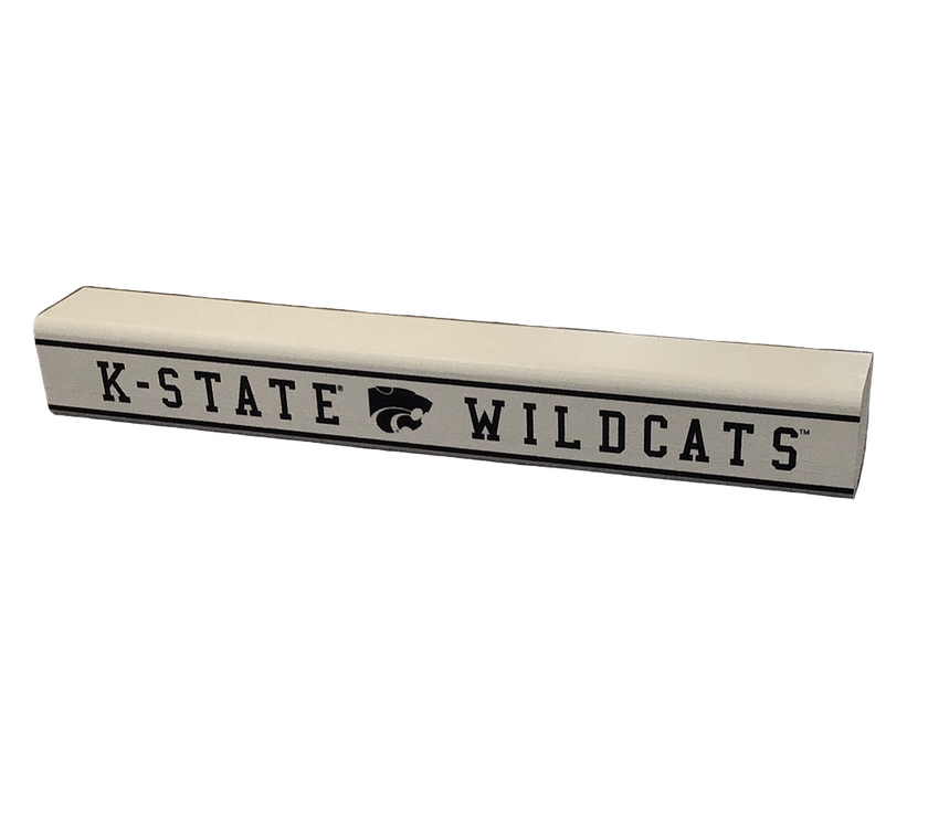 A small rectangular wooden sign with 'K-State Wildcats' printed on it in black with the school's logo in the middle.