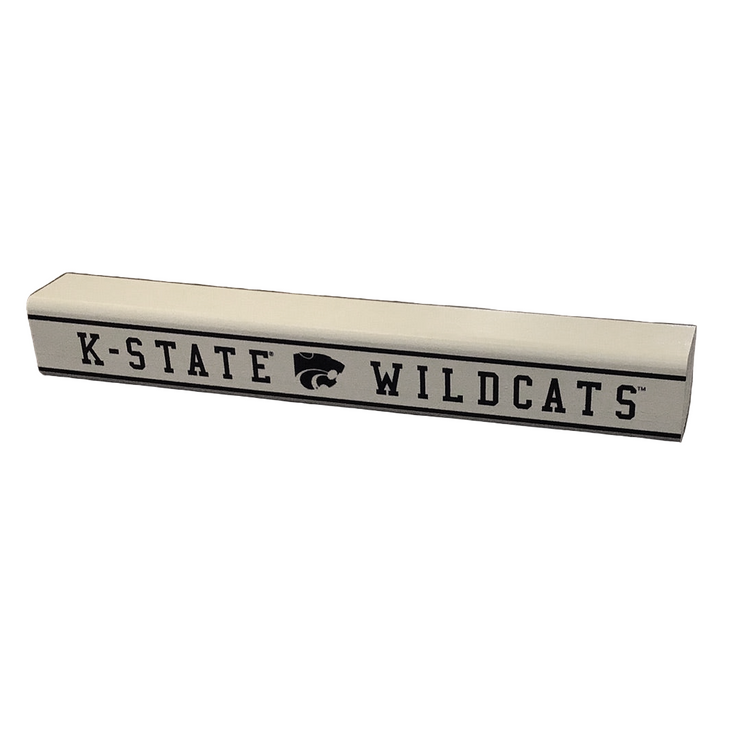 A small rectangular wooden sign with 'K-State Wildcats' printed on it in black with the school's logo in the middle.
