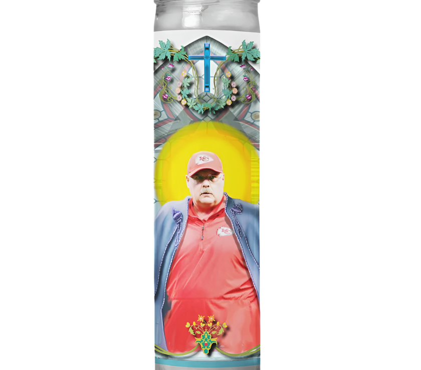 A prayer candle with a label featuring an image of Coach Andy Reid in a Kansas City Chiefs uniform, with a decorative border and a cross at the top.