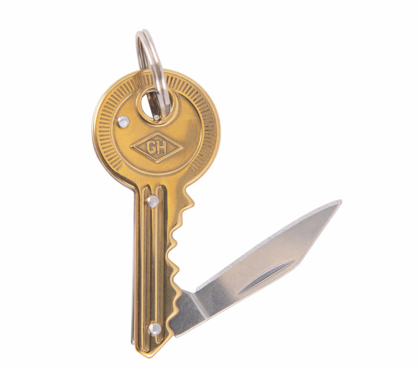 Key-shaped knife with a visible brand logo on a white background