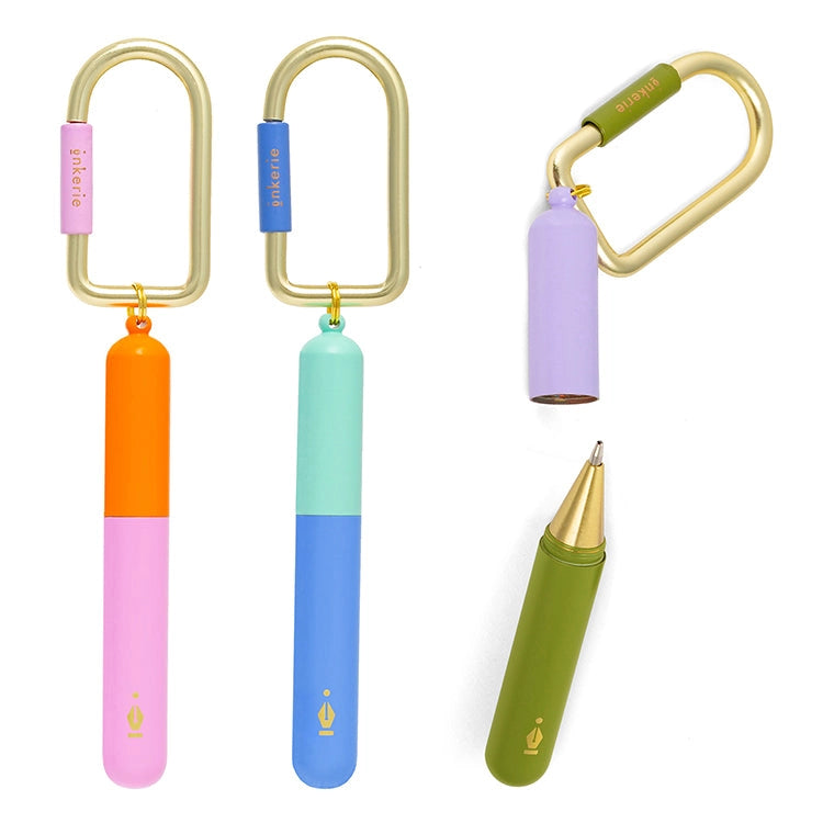 Colorful keychains with pens on carabiners on a white background