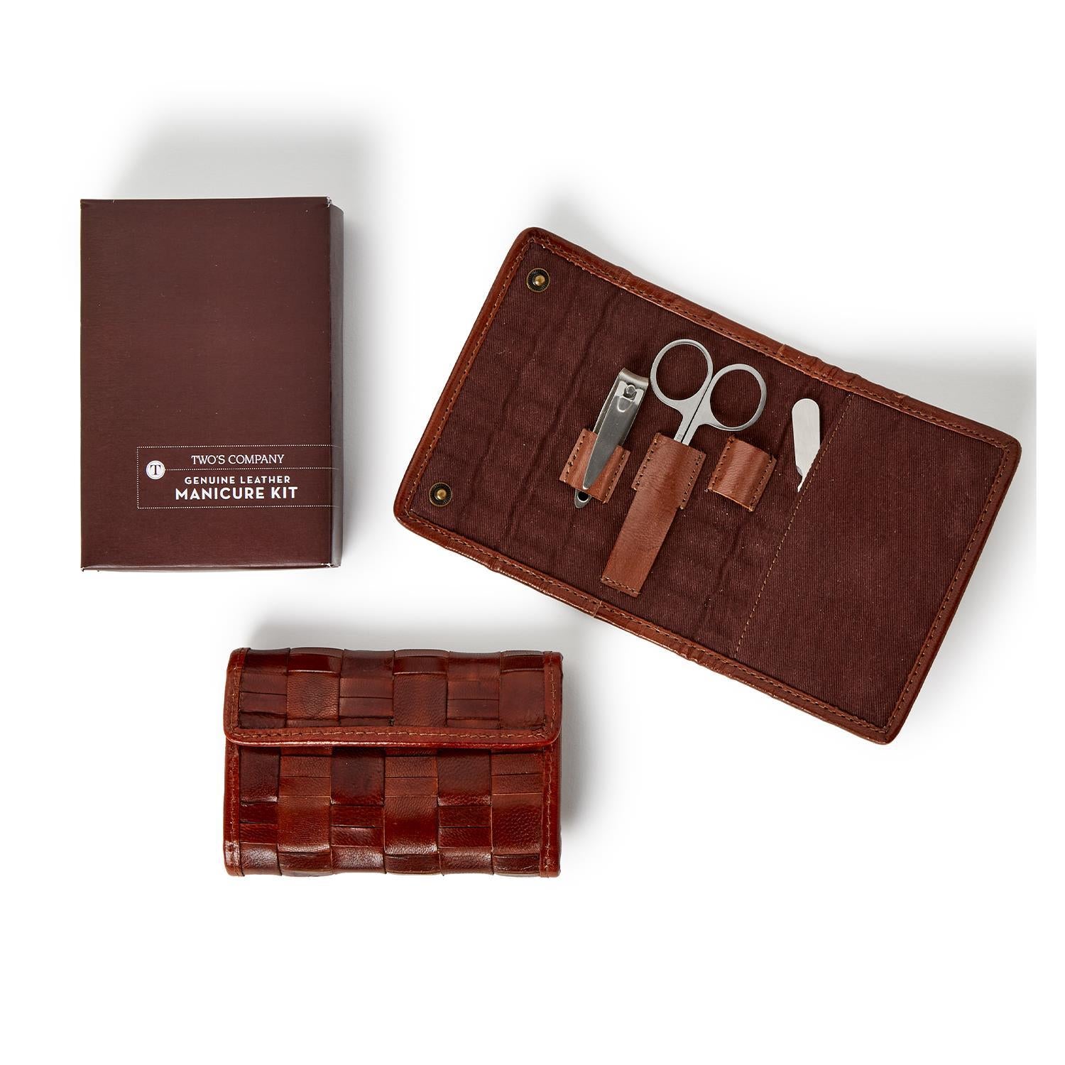 Brown leather manicure kit with tools and its packaging box on a white background
