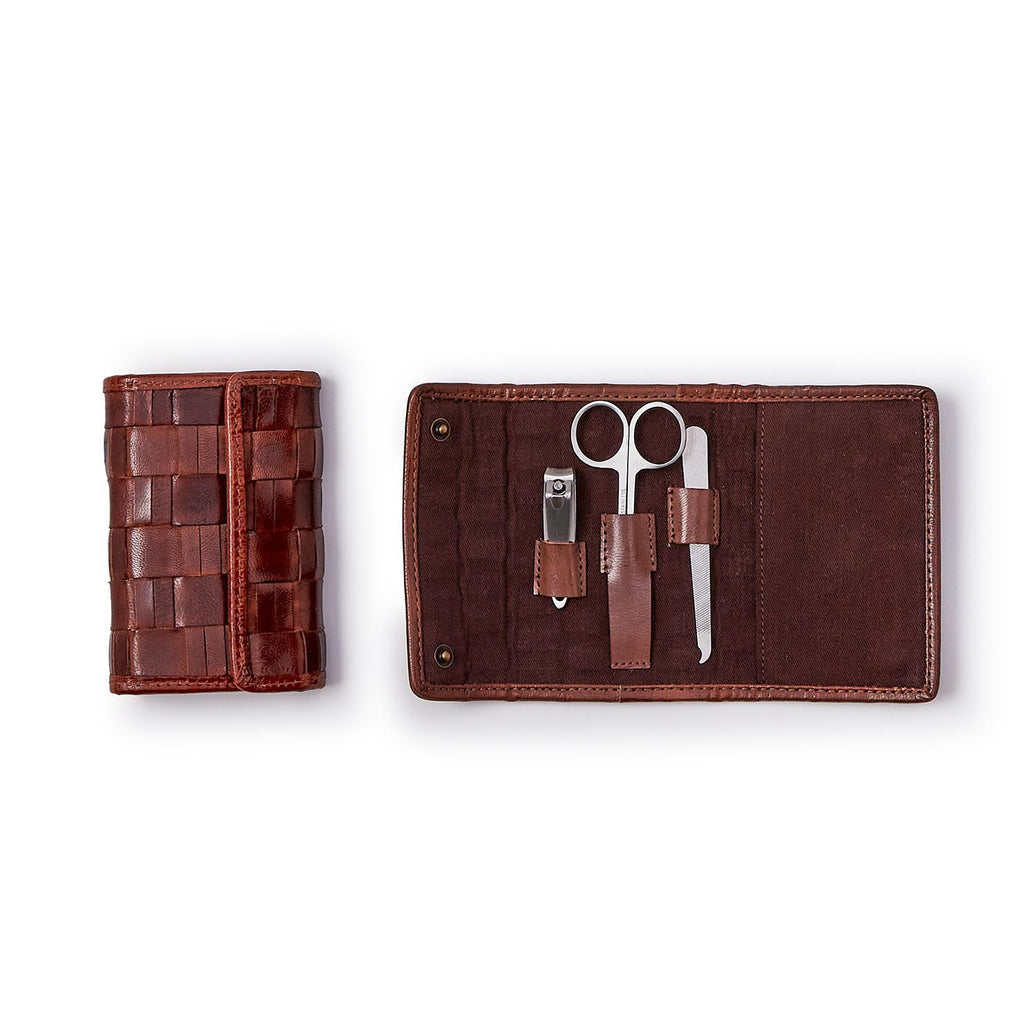 Manicure set in a brown leather case on a white background