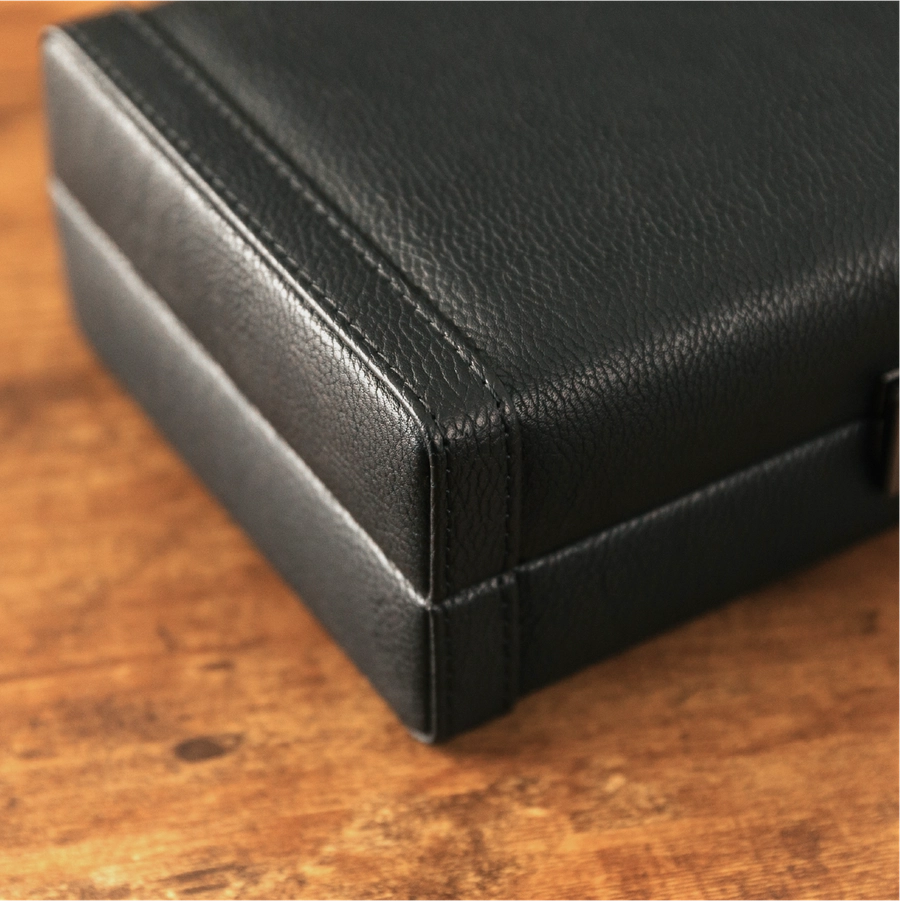Closeup of black vegan leather cigar case corner.