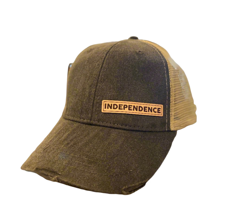 A black vintage-colored ball cap with a beige mesh and a leather patch on the front that reads 'INDEPENDENCE'.