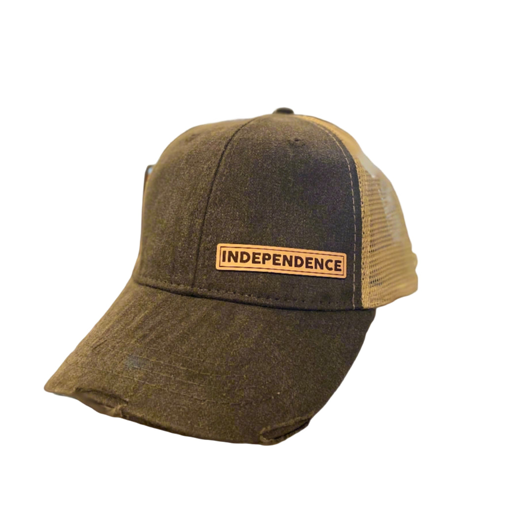 A black vintage-colored ball cap with a beige mesh and a leather patch on the front that reads 'INDEPENDENCE'.