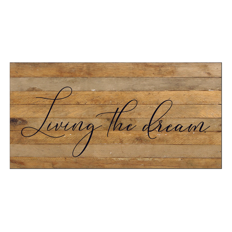 Wooden sign with 'Living the dream' text on a white background