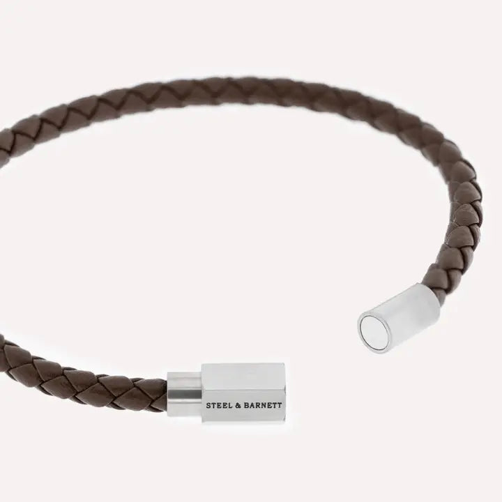 A closeup of the Luke Landon bracelet made of brown nappa leather and the Steel & Barnett logo on the silver clasp.
