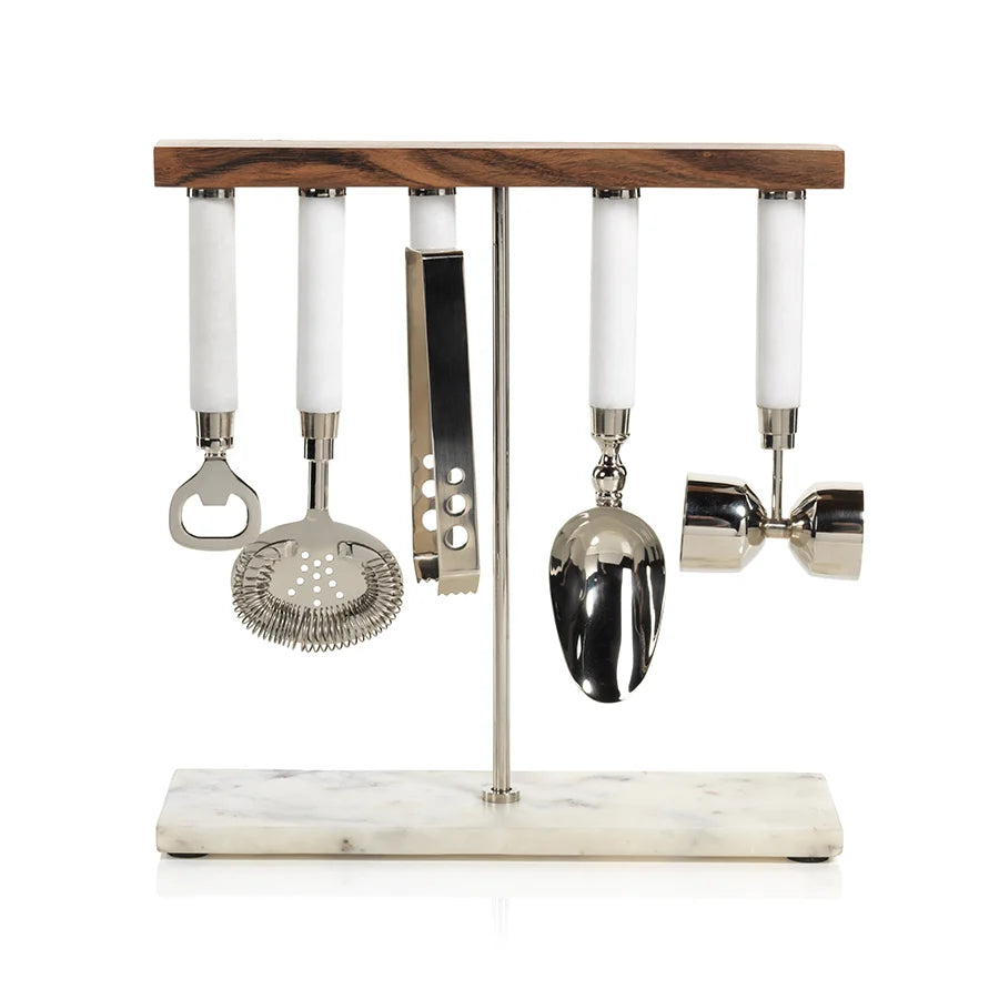A 5 piece bar tool set hanging from a wooden bar suspended with a metal pole and marble base on a white background.