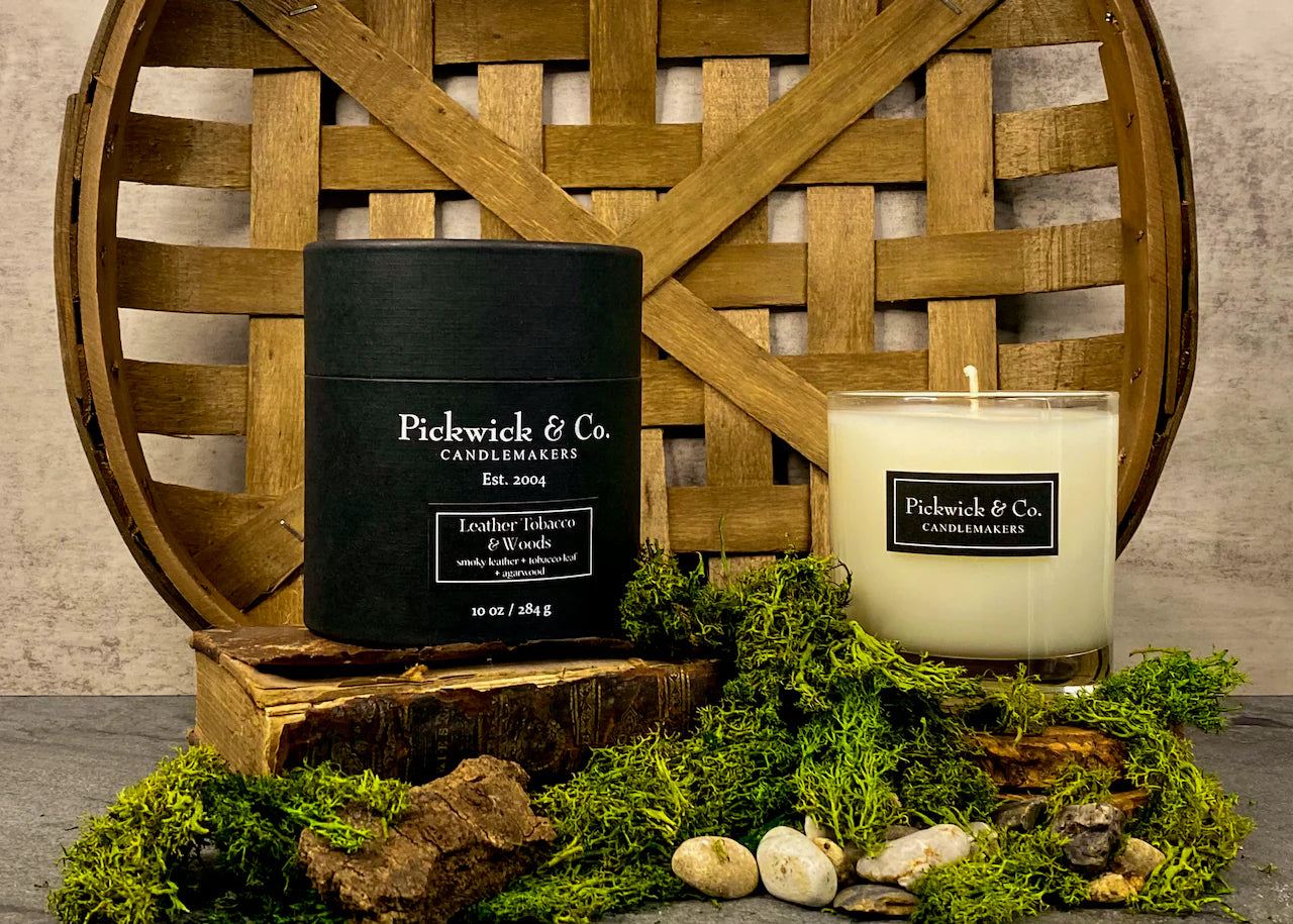Candle and packaging of Pickwick & Co. Candlemakers with a rustic wooden background.