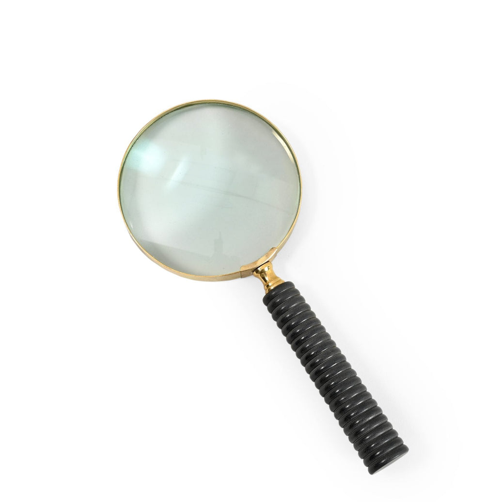 A magnifying glass with a black ribbed handle on a white background.