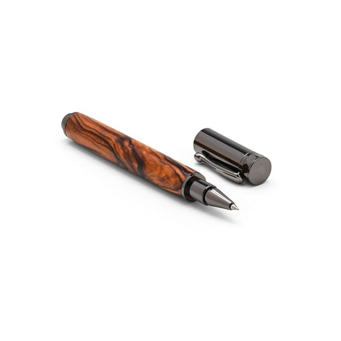An ironwood and gunmetal pen with the cap off and lying nearby.