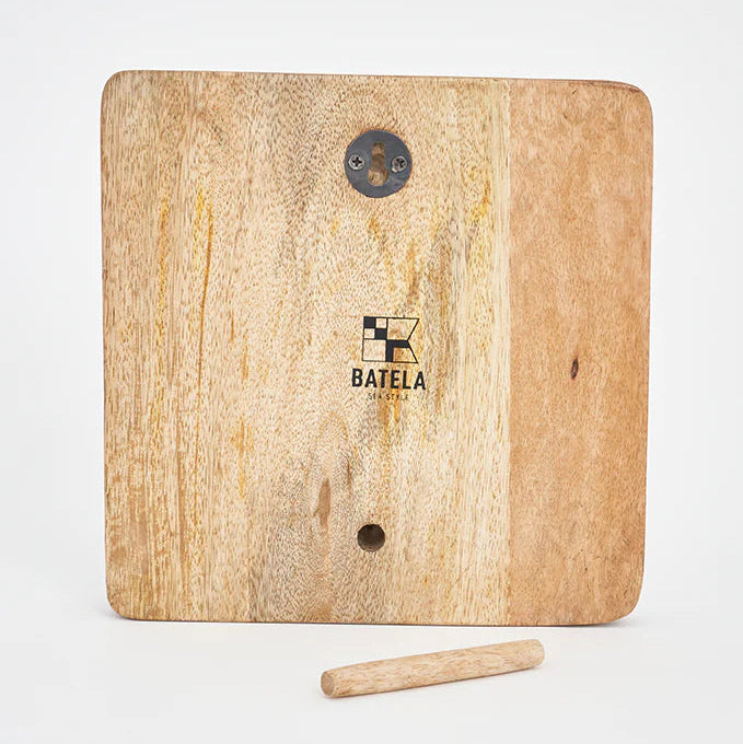 The backside of a decorative item featuring a black and white image of a beached traditional fishing boat on a wooden block that 